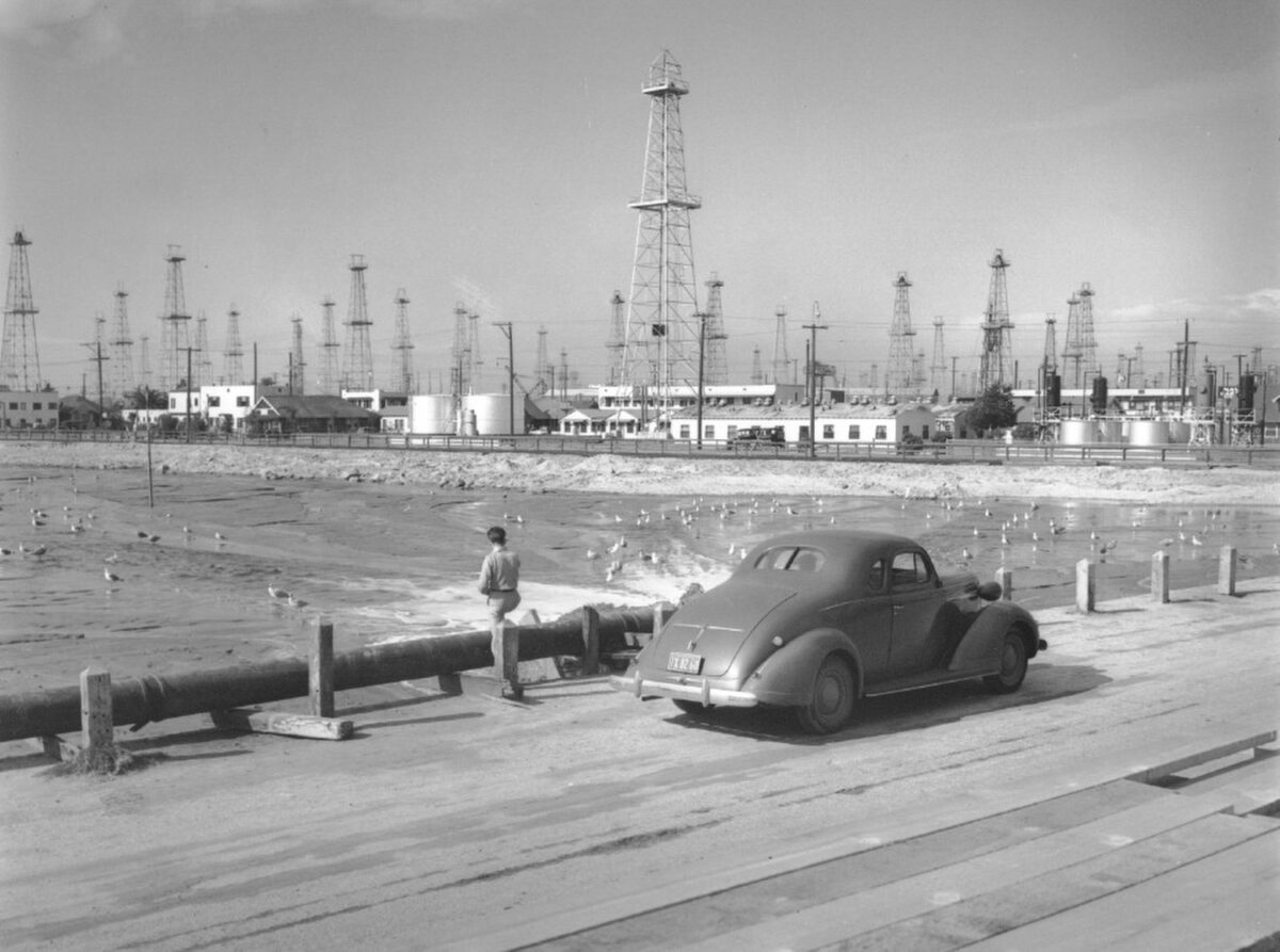 Oil wells dot the Long Beach harbor area in the late 1930s. The wells generated revenue for the City and Port but also created legal headaches and subsidence.