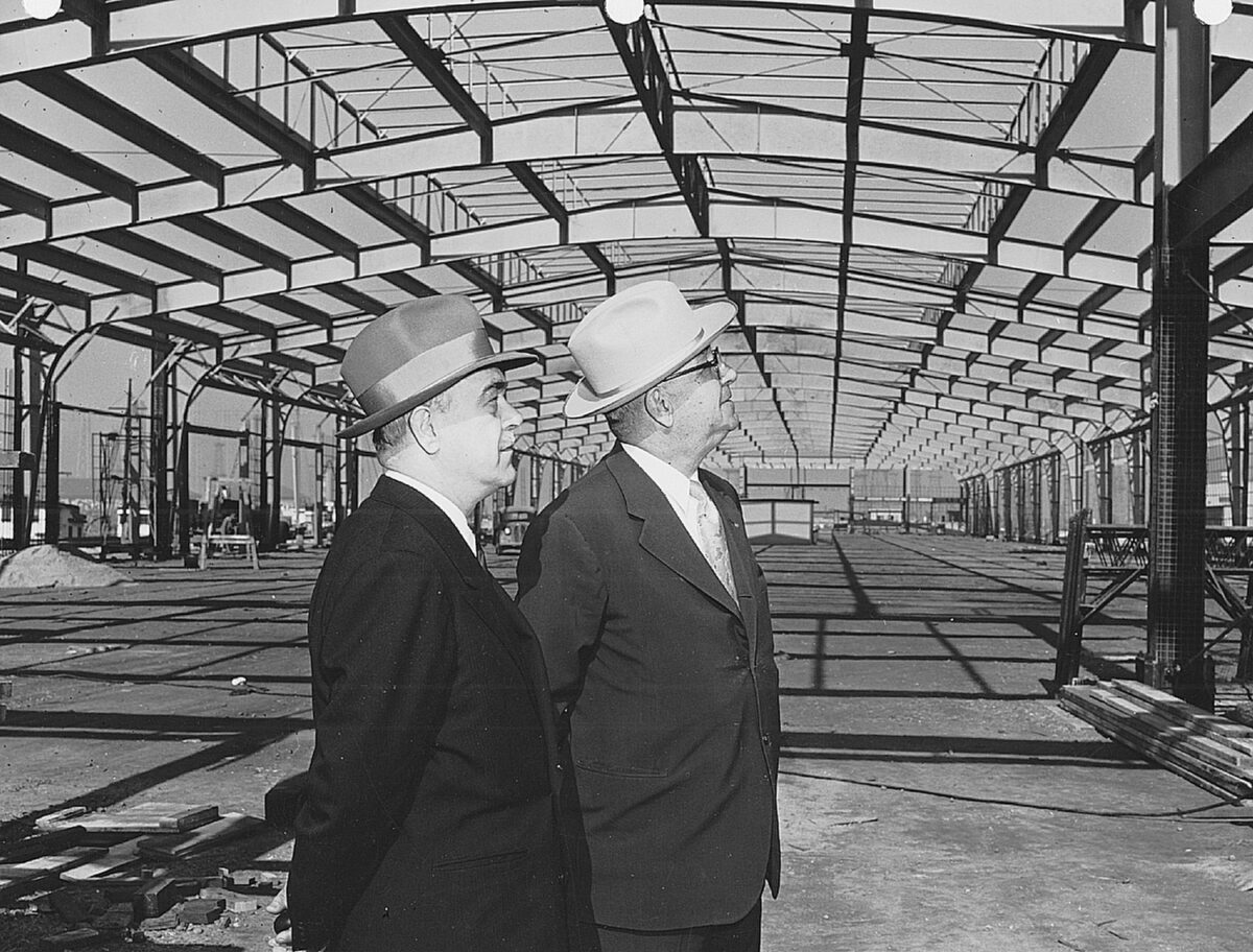 Harbor Commissioner John Davis and Port General Manager Eloi Amar inspect a new transit shed in 1954